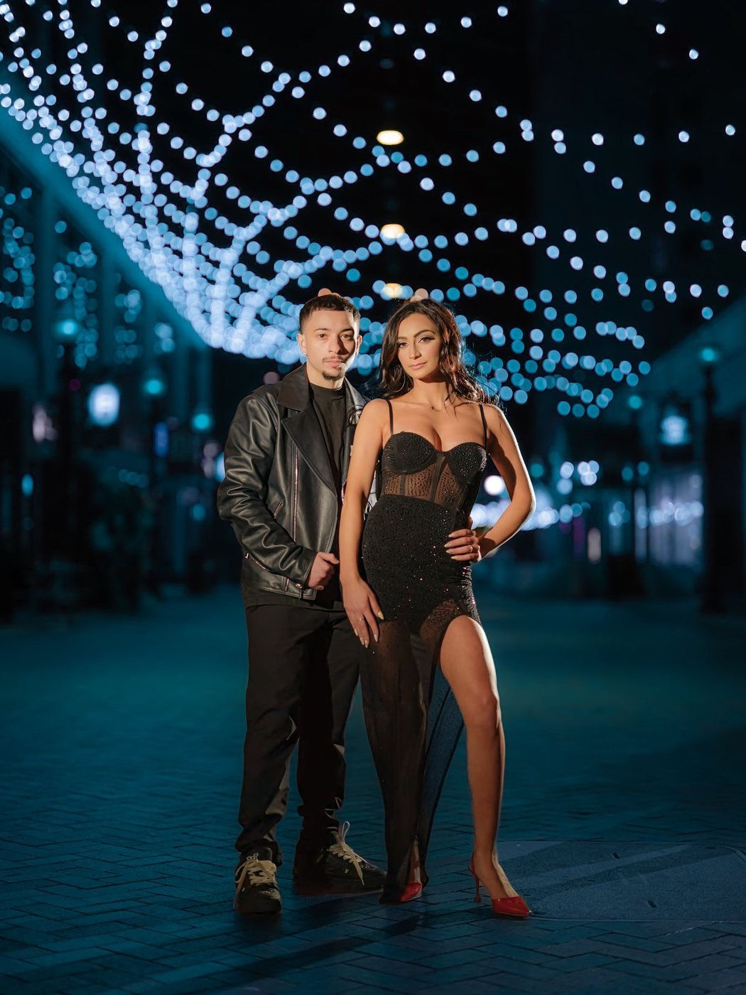 Couple under a canopy of night lights in Detroit