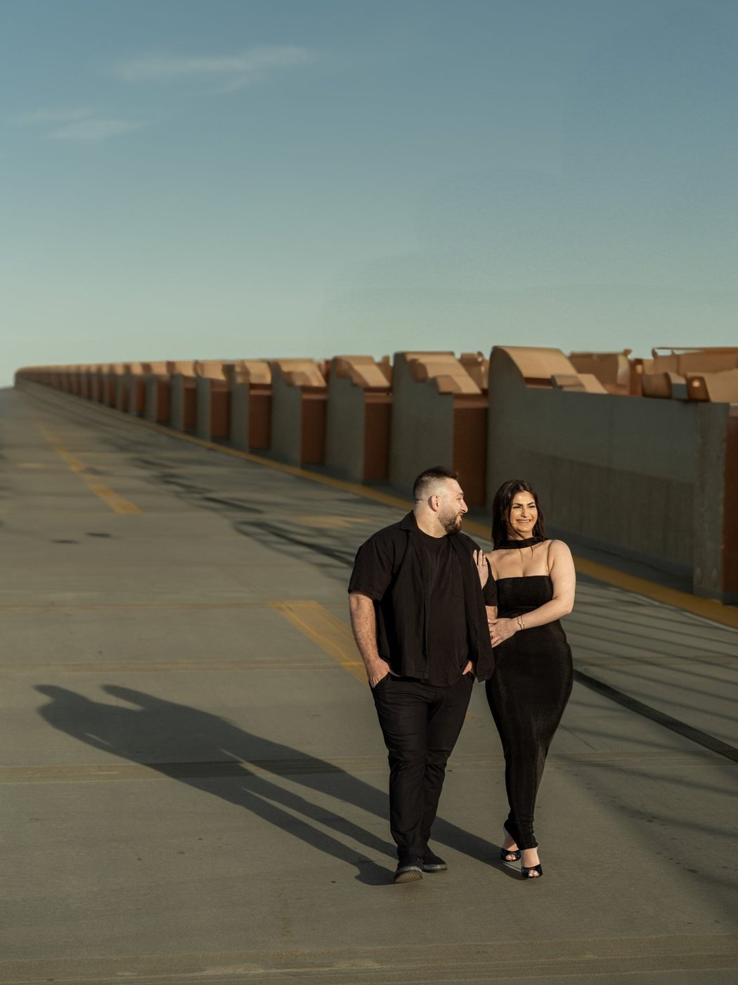 Couple walking an open road at dusk