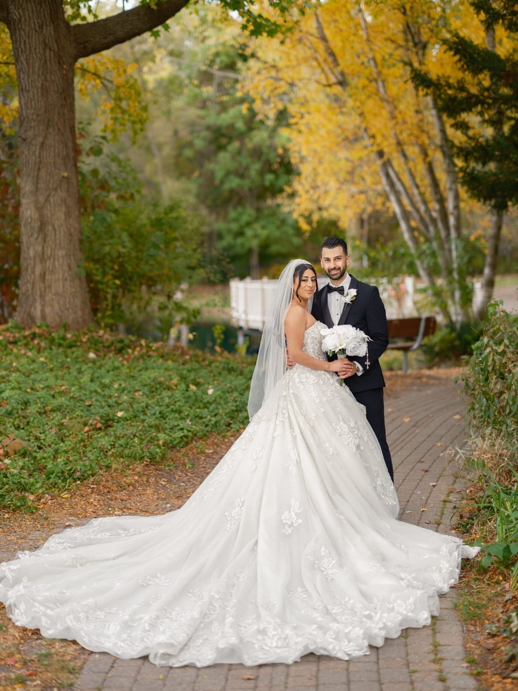 Bride with a long train among autumn colour