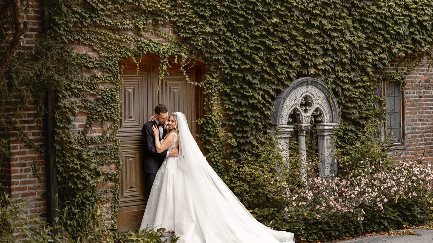 Bride beneath an ivy-covered stone archway