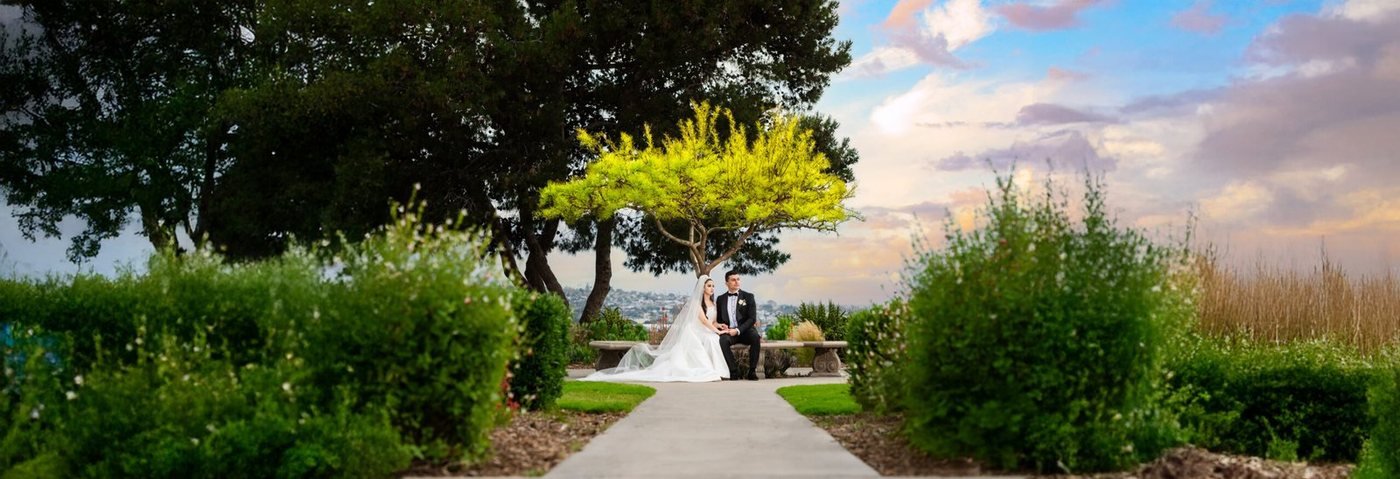 Couple framed by a formal garden vista