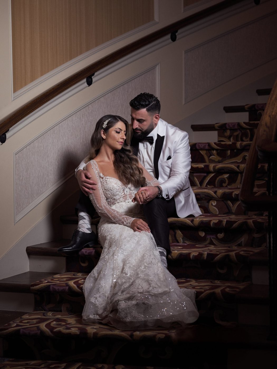 Bride and groom on a sweeping grand staircase