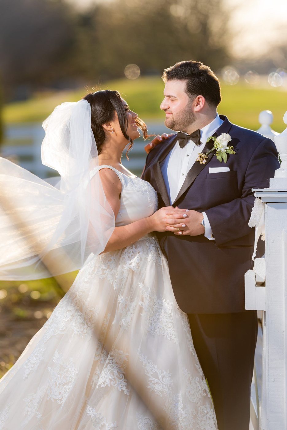 Bride and groom sharing a kiss beneath the veil