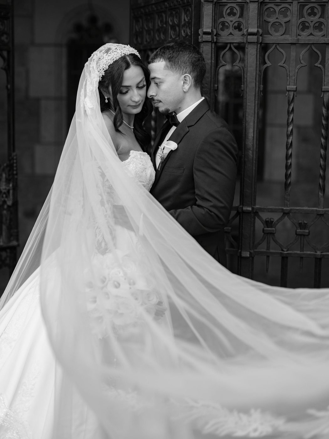 Veil sweeping around the couple, black and white
