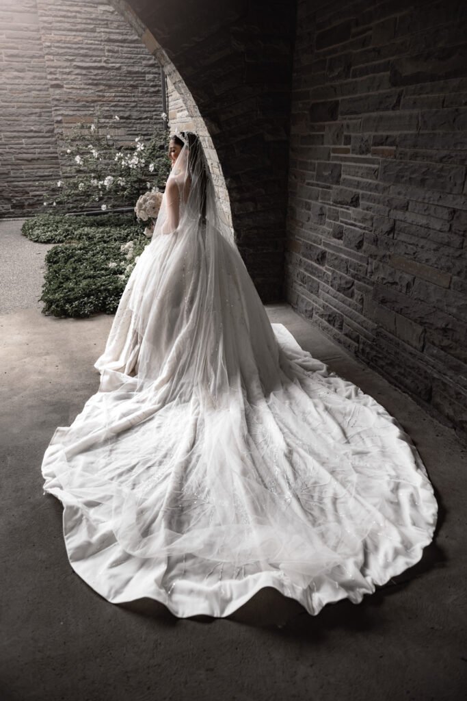 Editorial bridal portrait under a stone archway at a Michigan wedding venue, captured by Timeless Moments Studio.