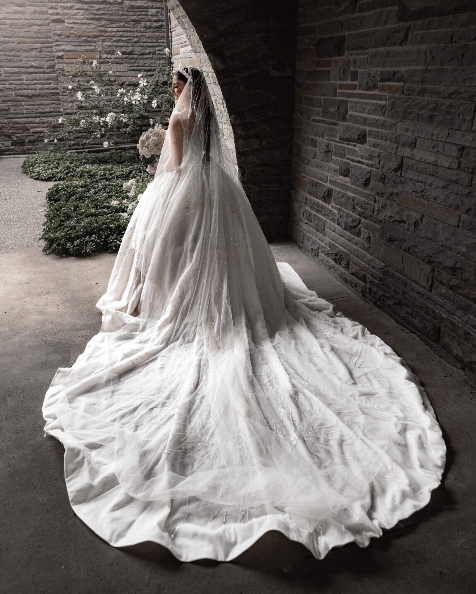 Editorial bridal portrait under a stone archway at a Michigan wedding venue, captured by Timeless Moments Studio.